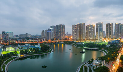 Fototapeta premium Cityscape of Hanoi skyline at Thanh Xuan park during sunset time in Hanoi city, Vietnam