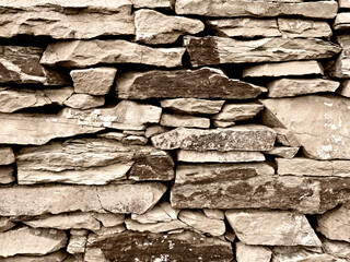 Close-up view of a weatherd stone wall in the vineyards, Germany. Background, grunge stone texture
