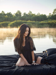 Fototapeta na wymiar Early morning on the river. Beautiful breakfast for the girl. Floating bed. Surprise and a gift for the girl. Boudoir photography. Romantic picnic.
