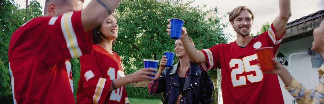 Diverse group of college students friends dancing outside during a party celebration. Spring break games, college life. Shot on RED cinema camera with 2x Anamorphic lens