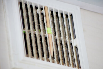 ventilation grill in the dust of dirt in the kitchen, close-up