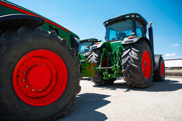 Professional modern tractor, combine at a field in sunlight at work. Vibrant, bright summer colors....