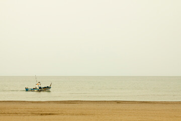 boat fishing in the sea near the beach.