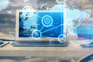 Computer on desktop with social network theme icon. Multi exposure. Concept of international connections.