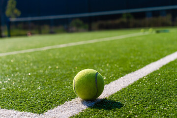 Tennis Racket on empty tennis grass court