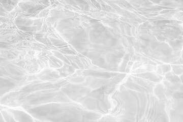 Closeup of desaturated transparent clear calm water surface texture with splashes and bubbles. Trendy abstract nature background. 