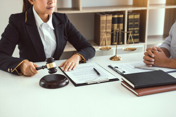 Lawyer is explaining about the wrongdoing laws regarding fraud to the client at the office.