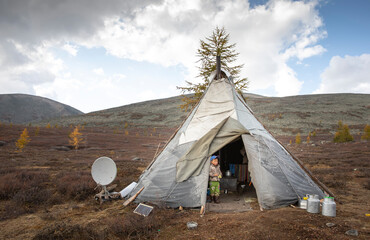 tsaatan boy at the door of his home yurt