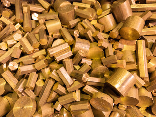 a pile of industrial scrap - brass turning leftovers and cutt off waste - waiting for recycle.