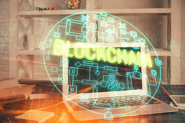 Multi exposure of blockchain theme hologram and table with computer background. Concept of bitcoin...