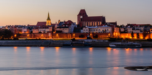 Sightseeing of Poland. Cityscape of Torun old town and Vistula river at night. UNESCO world heritage in Poland © r_andrei