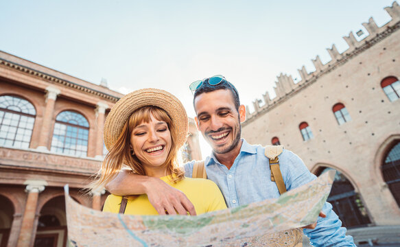 Young couple in Rome. Boyfriend and girlfriend holding city map visiting the beautiful italian city at holiday moment 
