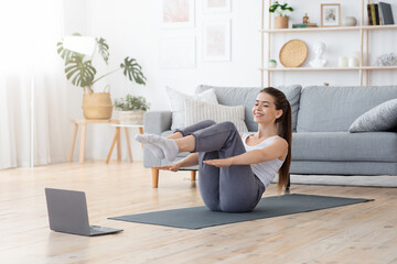 Energetic young lady having workout at home