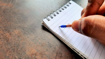 Asian businessman making notes on daily strategy or goals