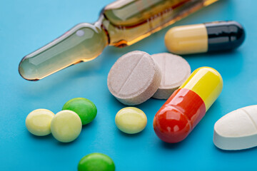  Multi-colored pills and injections for treatment. Pharmaceutical industry. Pharmacy.