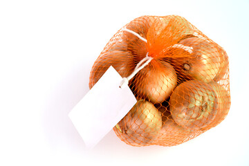 Top view of onions in net bag with tag placed on isolate background