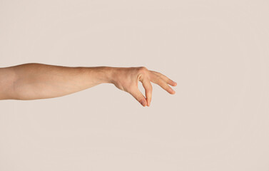 Closeup of male hand holding something on light background, mockup for design