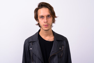 Young handsome rebellious man against white background