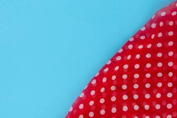 Colorful red fabric cloth texture with white circle round dot on a blue background