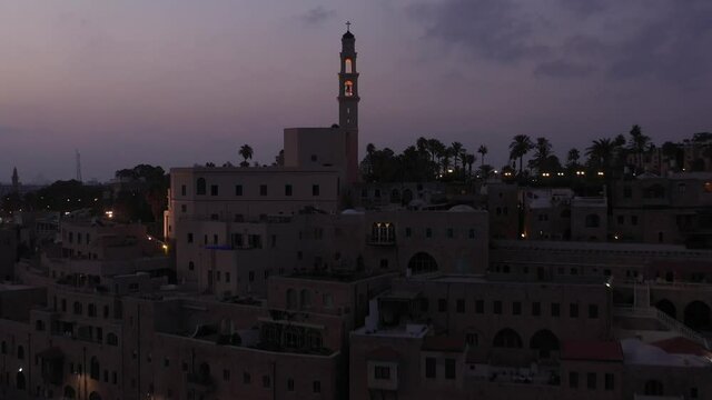 Aerial view of Jaffa old city port at sunrise with marina coastline and general view of both Jaffa and Tel Aviv.
