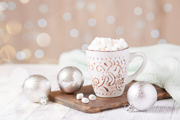 Mug with coffee and marshmallow on wooden table . Cozy christmas composition. Hygge concept Soft focus