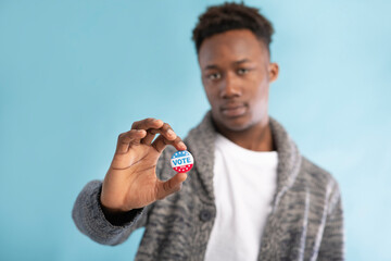 Vote button in hand of african american voter