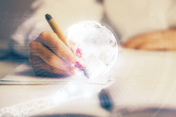 Multi exposure of hands making notes with world map hologram and data theme icons. Concept of global data.