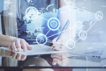 Social network theme hologram over hands taking notes background. Concept of global international people connect. Double exposure