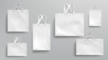 Paper shopping bags mockup, white packages with rope and lace handles, blank rectangular ecological gift packs, isolated mock up for branding and corporate identity design, Realistic 3d vector set