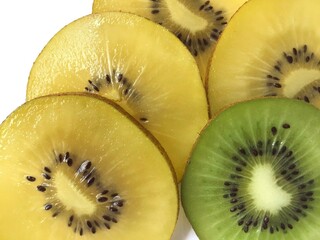 slices of fresh green and yellow kiwi fruits as a food background texture