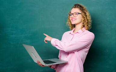 online education. business school. teacher woman at blackboard. e-learning concept. Education via Internet. modern technology. girl in modern school. happy student in glasses with laptop. copy space