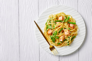 Salmon and green bean pasta on a plate, copy space