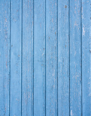 cracked bright blue paint on wooden planks
