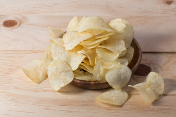 Close up potato chips on wood top view background.