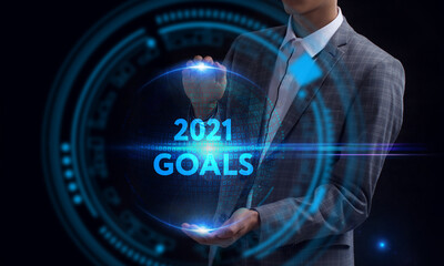 Business, Technology, Internet and network concept. Young businessman working on a virtual screen of the future and sees the inscription: 2021 goals