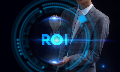 Business, Technology, Internet and network concept. Young businessman working on a virtual screen of the future and sees the inscription: ROI