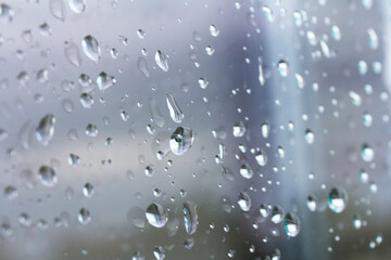 A small raindrop rests on the glass after rain.