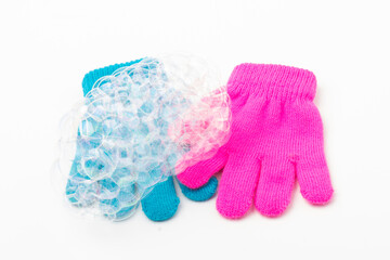 Child  brighte gloves whith soap bubble on white background.
