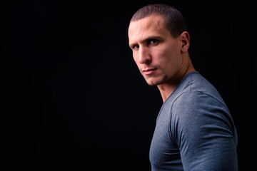 Naklejka premium Face of man with short hair against black background