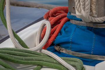 Fototapeta na wymiar Red, Green and White Ropes With Blue Sail Cover