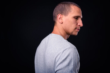 Obraz premium Face of man with short hair against black background