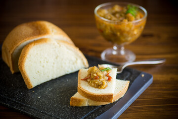 cooked eggplant caviar with spices on a wooden table