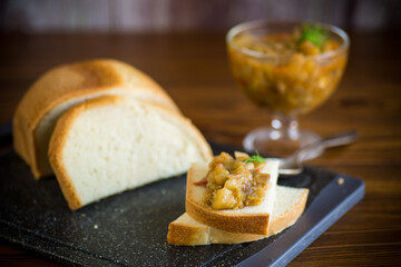cooked eggplant caviar with spices on a wooden table