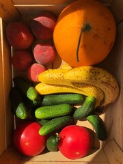 Seasonal fruits and vegetables in a wooden box
