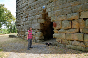 frau steht vor dem wohnturm und bergfried von burg sponheim