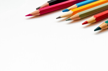 Colored pencils close up on white background