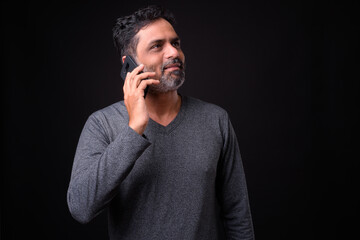 Portrait of mature bearded Indian man with curly hair