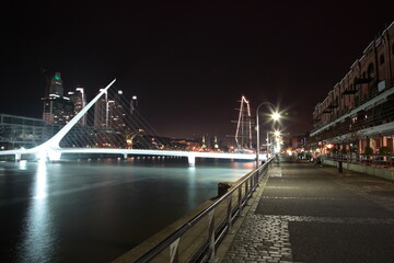 Obraz premium View of Women's Bridge and The Waterfront with crane at night in Buenos Aires, Argentina