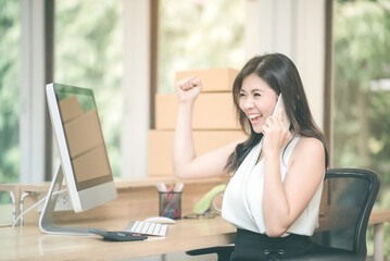 Young entrepreneur happy and celebration for achievement success mission while talking to her marketing team at home office.Conceptual for small businesses starting own company and online marketing.