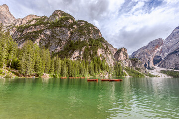 Wooden pleasure boats on the famous Braies lake. Italian dolomite alps.
